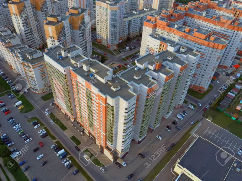 129466096-drone-view-of-new-building-complex-in-city-center-with-houses